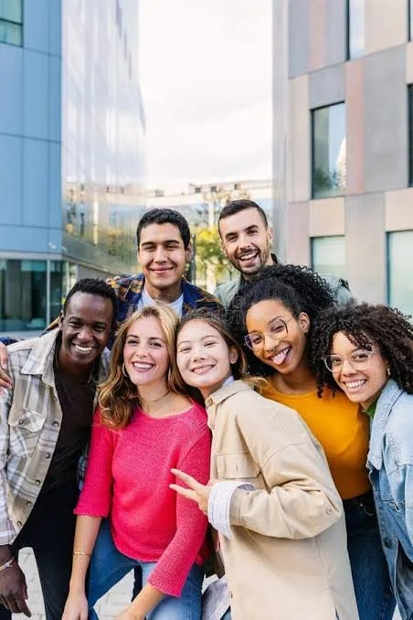 A diverse group of friends together outside a city building